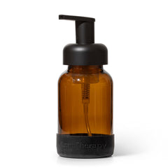 Brown bottle with black pump and 'Herb Therapy' branding on a white background