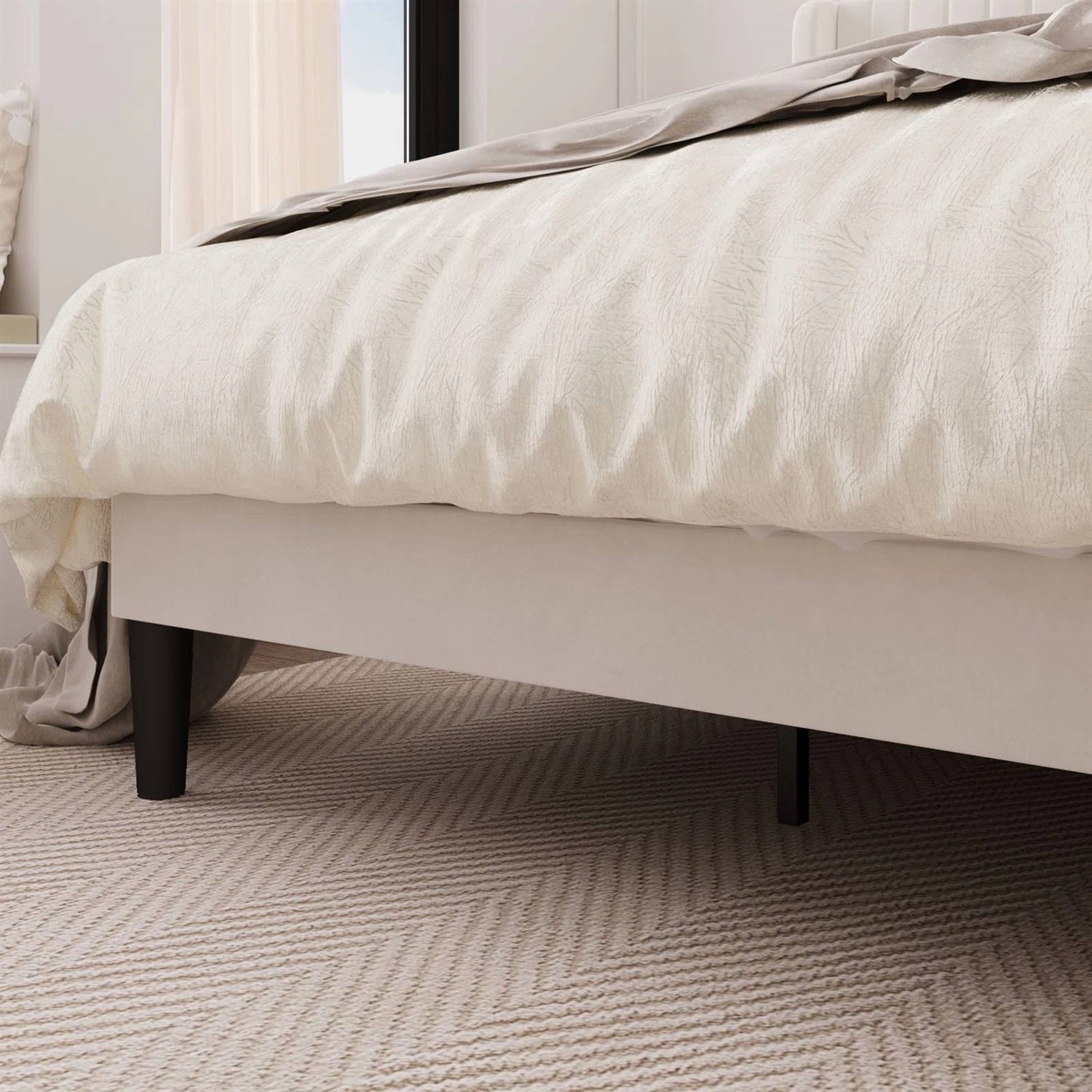 Close-up of a bed with white bedding on a textured carpet