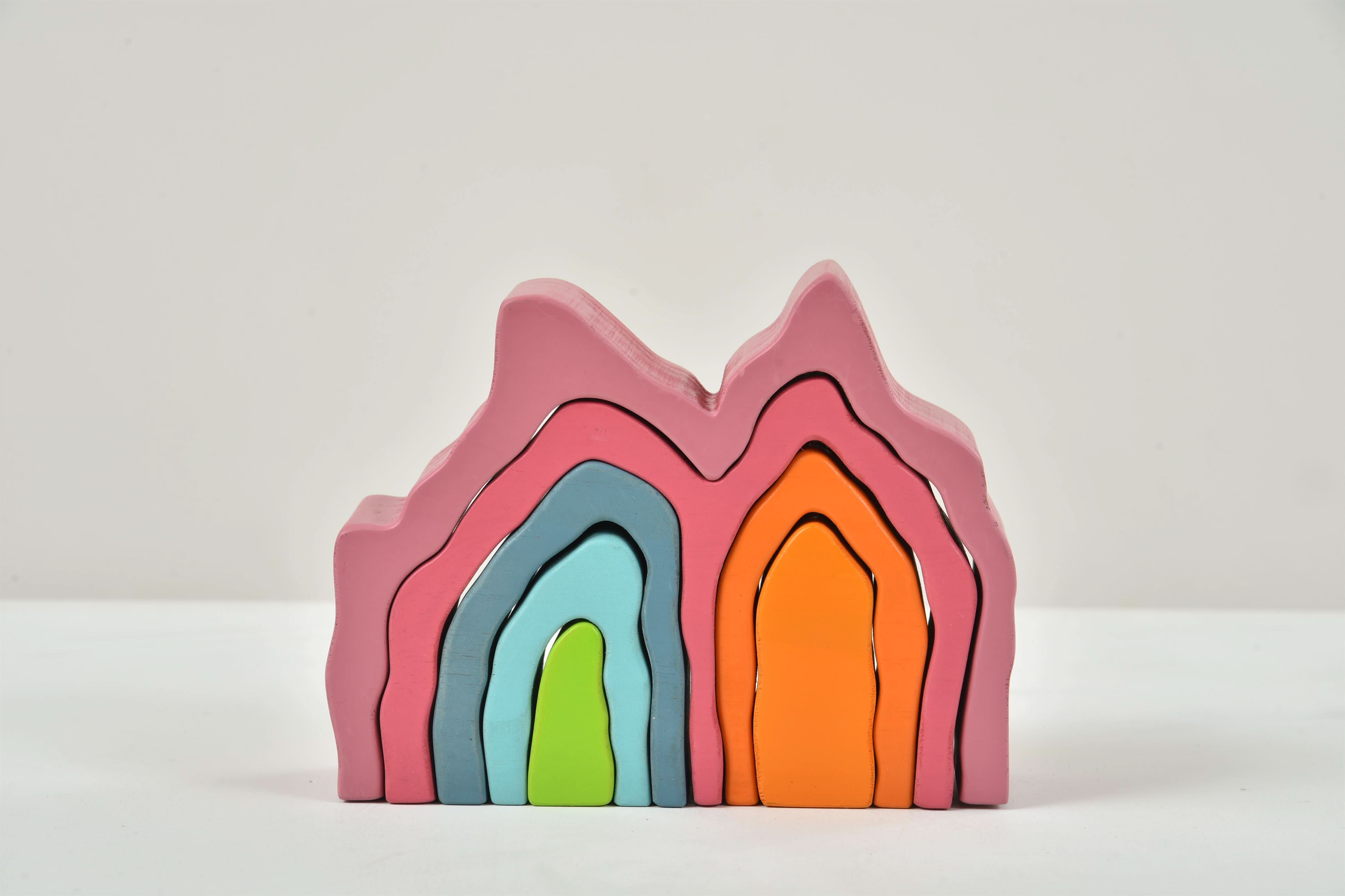 Stack of colorful wooden toys on a light gray background