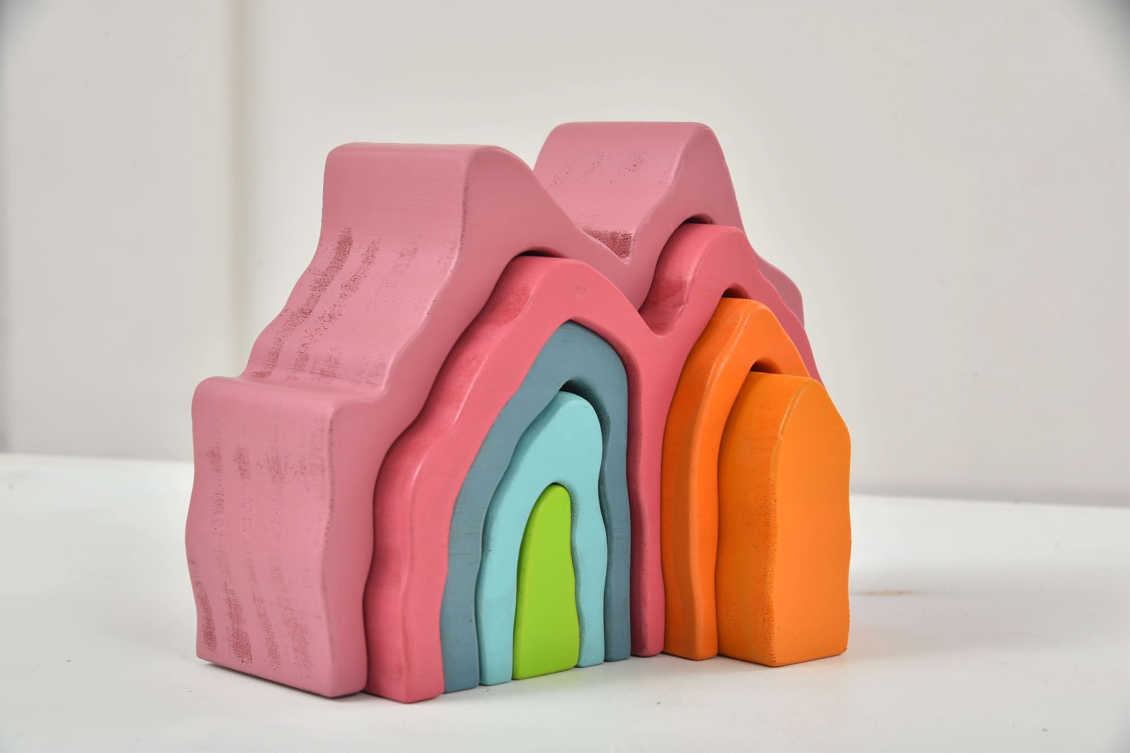 Set of colorful foam blocks stacked on a white surface with a light gray background