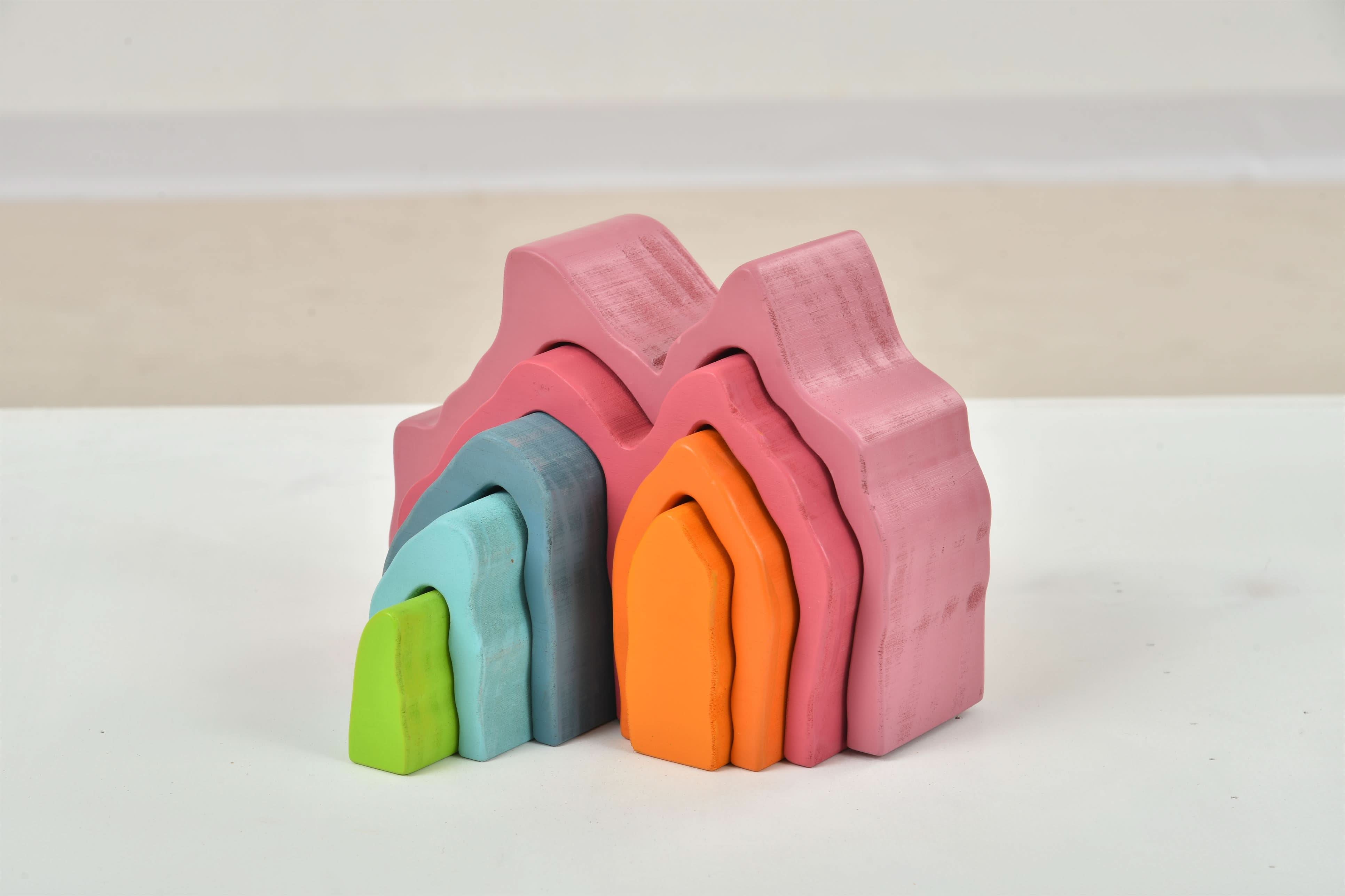 Stack of colorful building blocks on a white surface