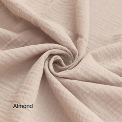 Close-up of beige fabric with 'Almond' label