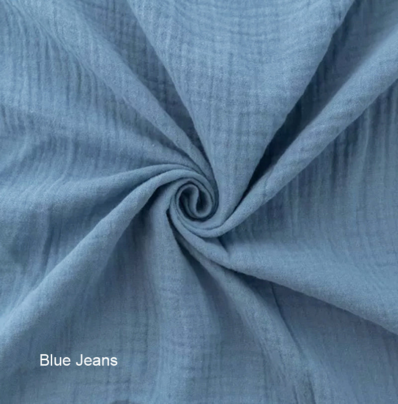 Close-up of blue jeans fabric with a swirl pattern