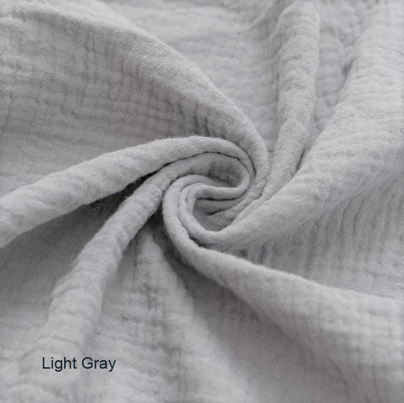 Close-up of light gray fabric with a subtle texture.