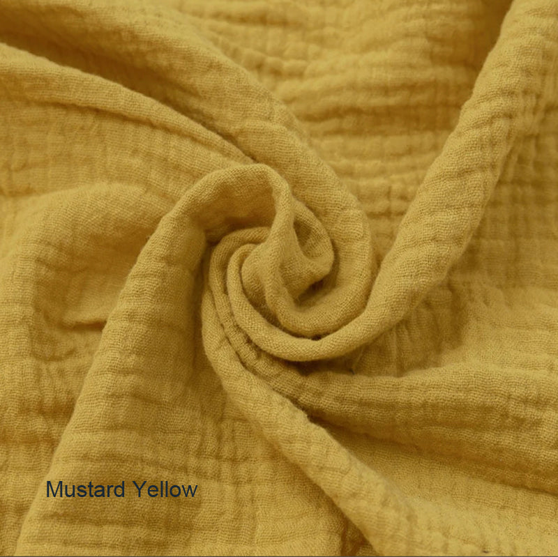 Close-up of mustard yellow fabric with a textured pattern