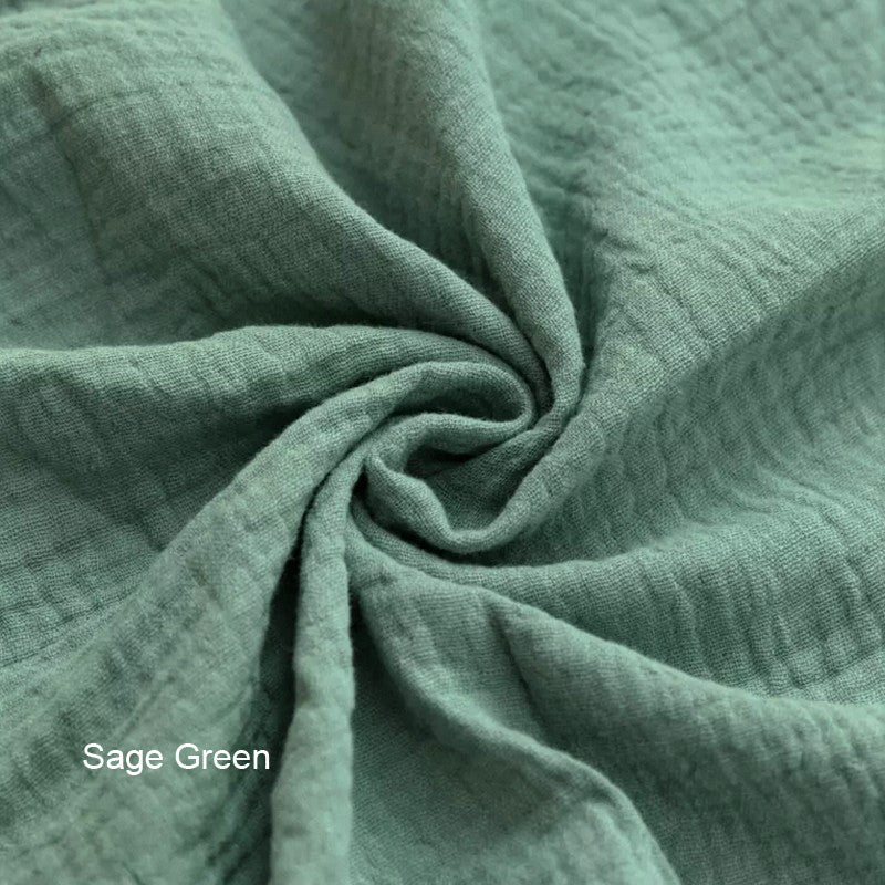 Close-up of sage green fabric with a subtle pattern