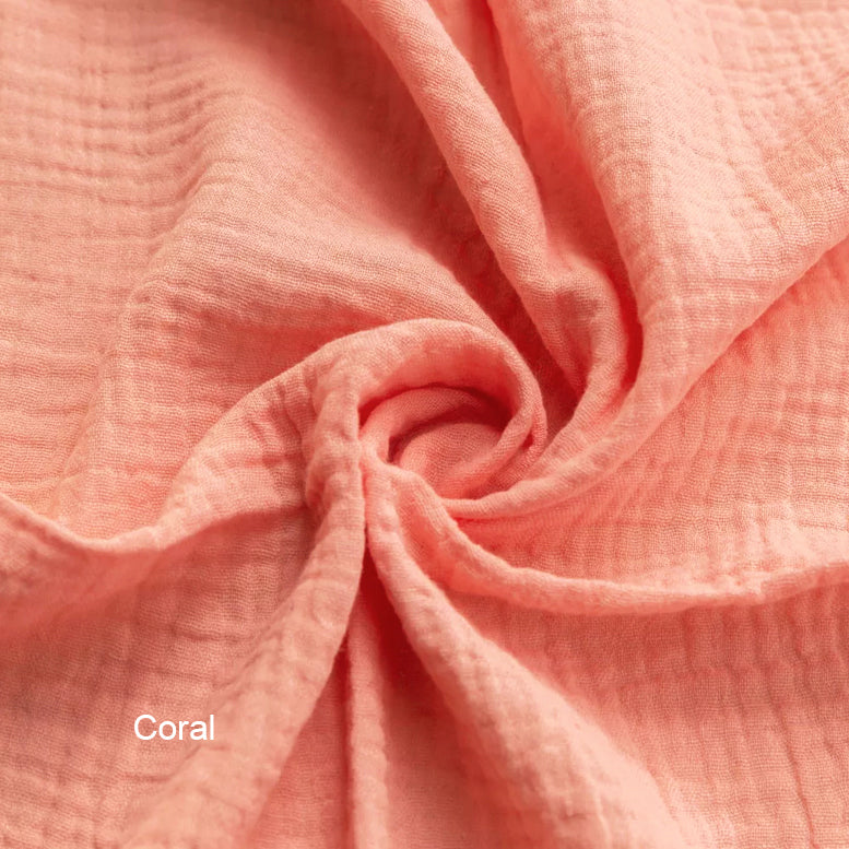 Close-up of coral fabric with a swirl pattern