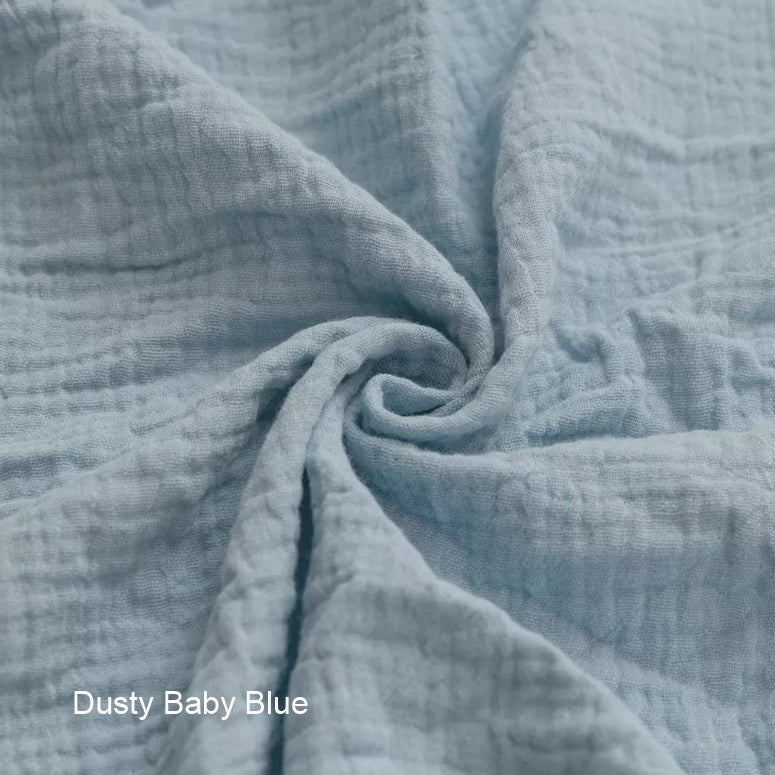 Close-up of textured dusty baby blue fabric with 'Dusty Baby Blue' label.