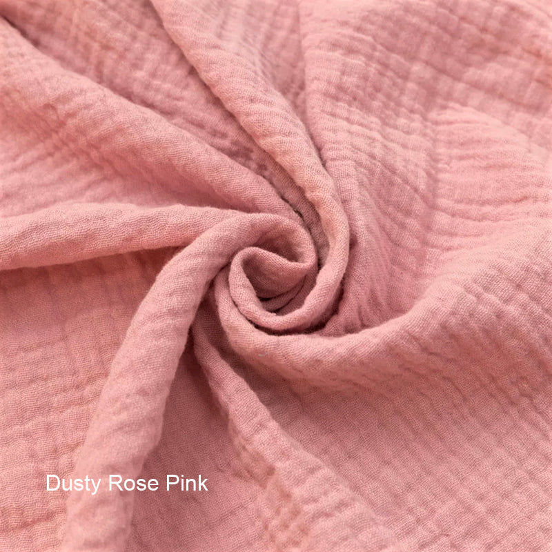 Close-up of dusty rose pink fabric with a swirled pattern