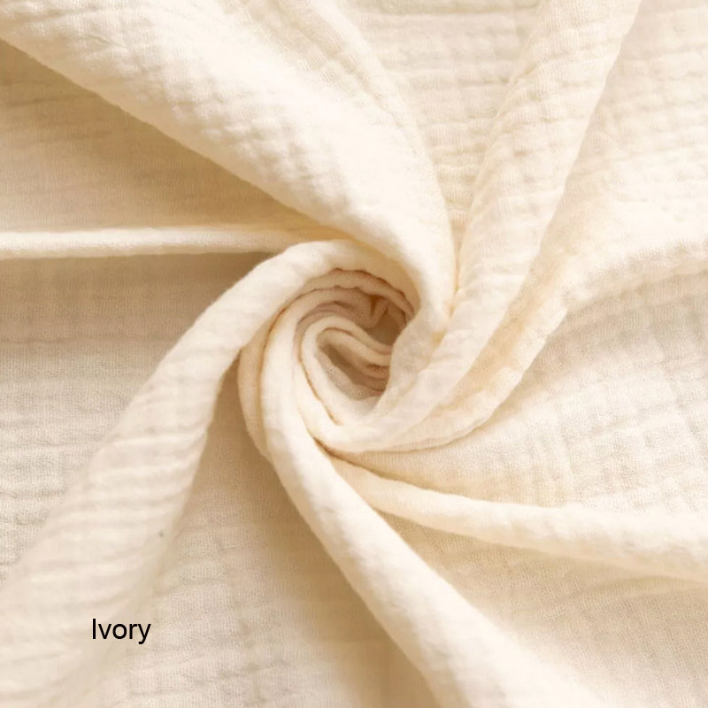 Close-up of ivory fabric with a visible label