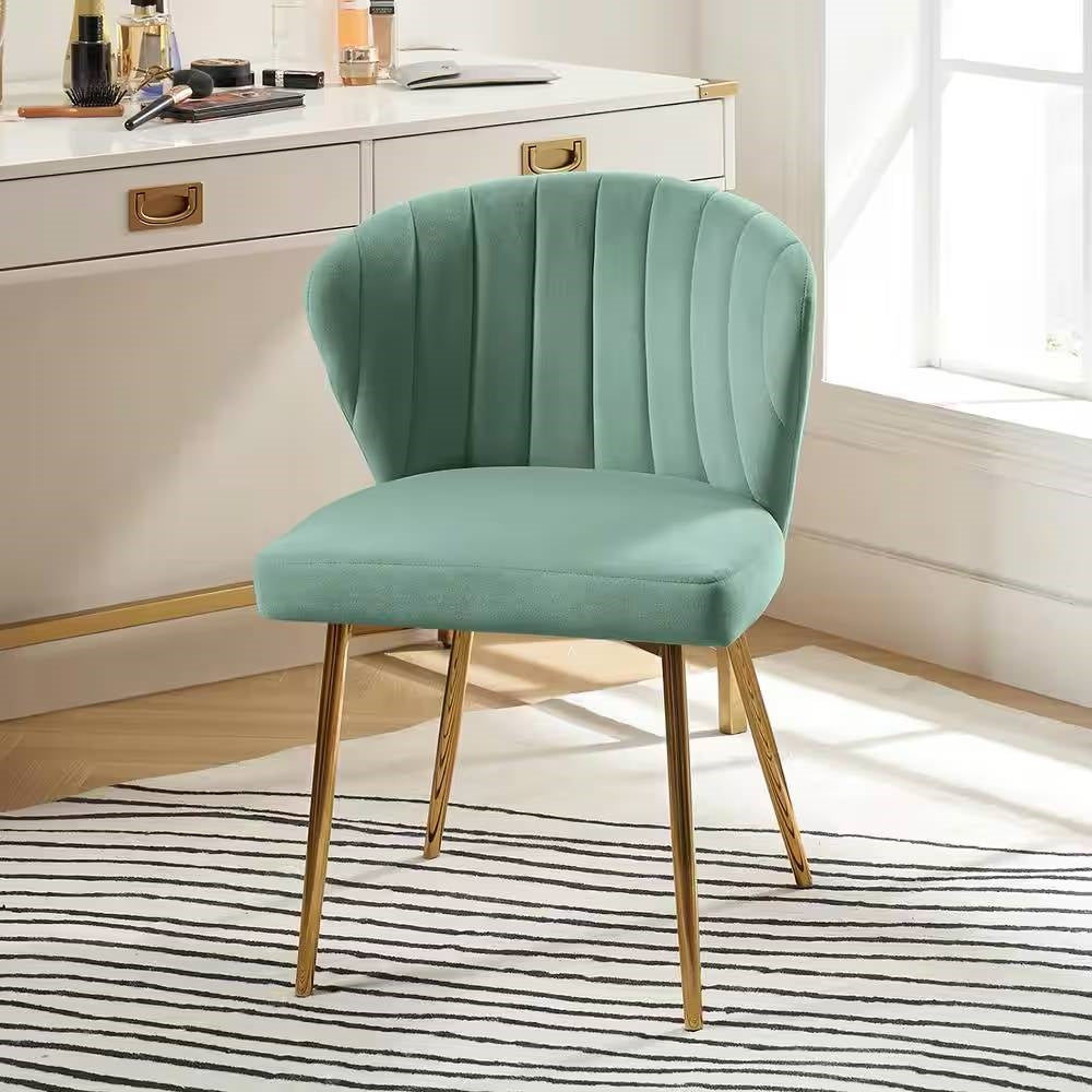 Teal chair with gold legs in a room with a desk and window.