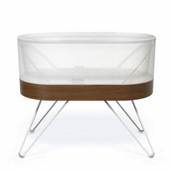 Wooden crib with mesh side on a white background