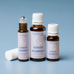 Three bottles of Plant Therapy 'sweet slumber' essential oil blend on a blue background