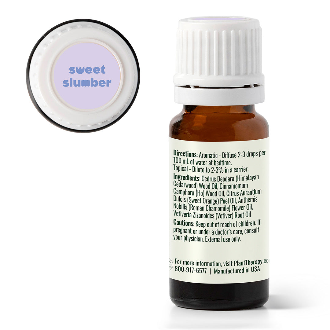 Essential oil bottle labeled 'sweet slumber' with a white cap on a white background