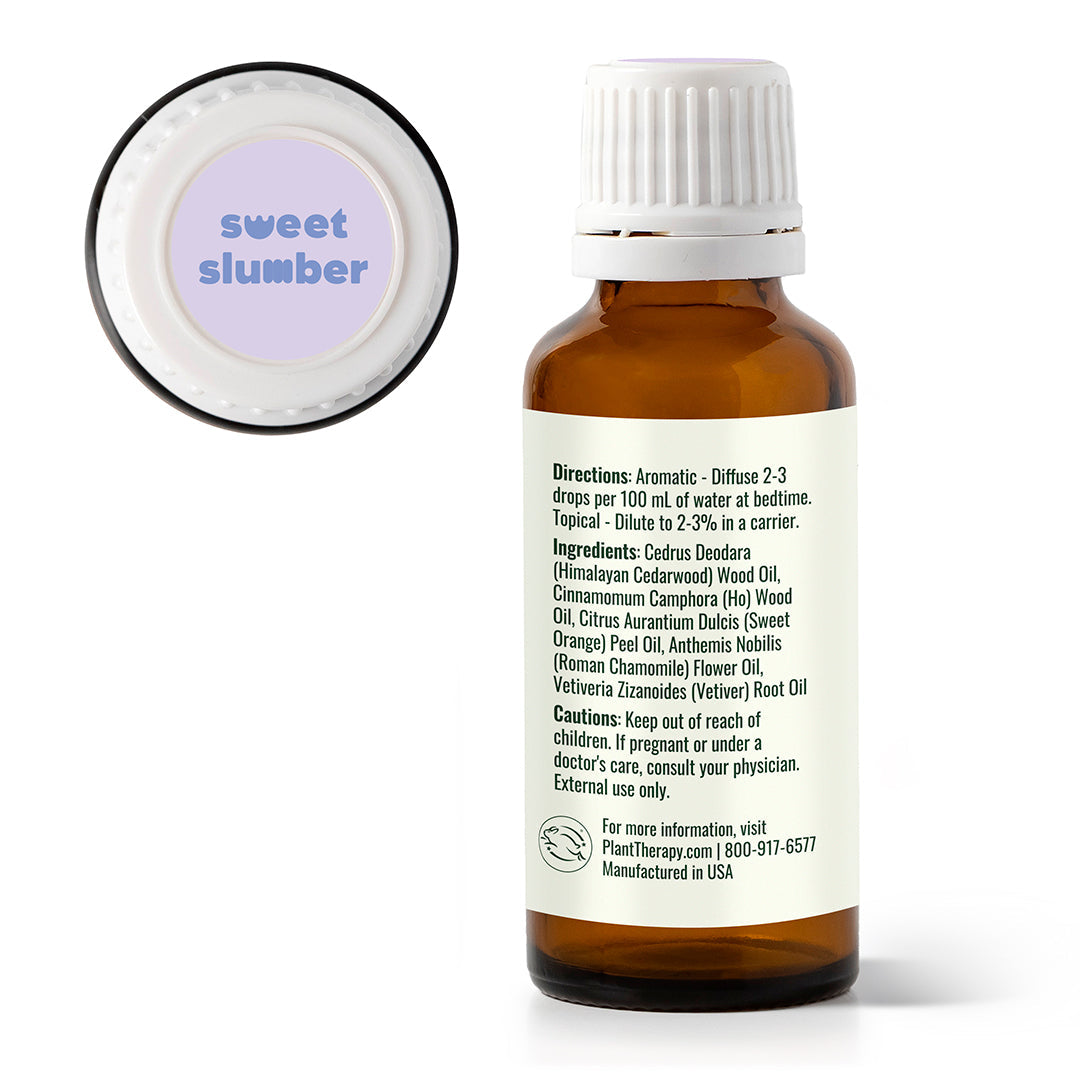 Bottle of essential oil labeled 'sweet slumber' with a white cap on a white background.