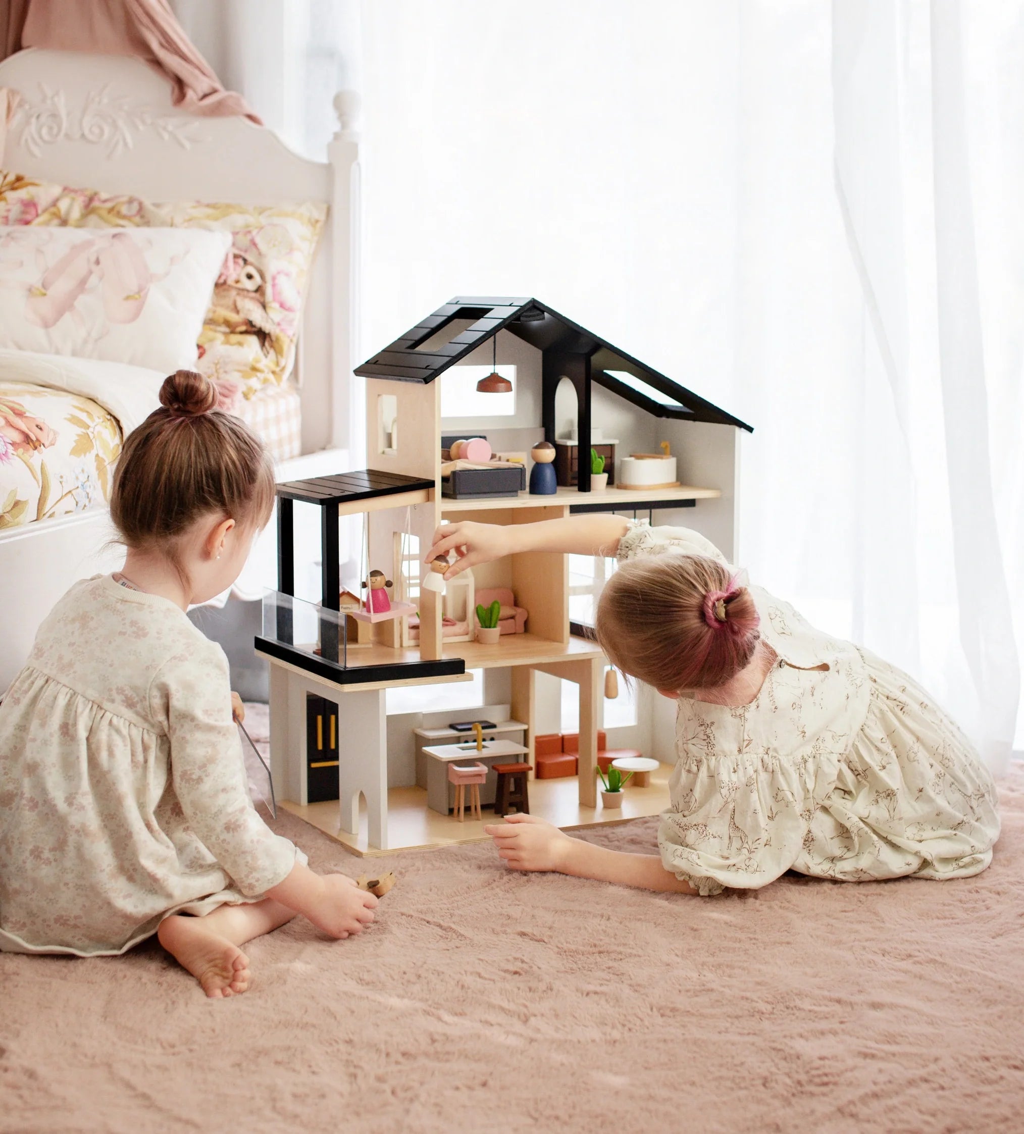 Side view of Sweetwood Edge wooden dollhouse showing three floors and open room layout