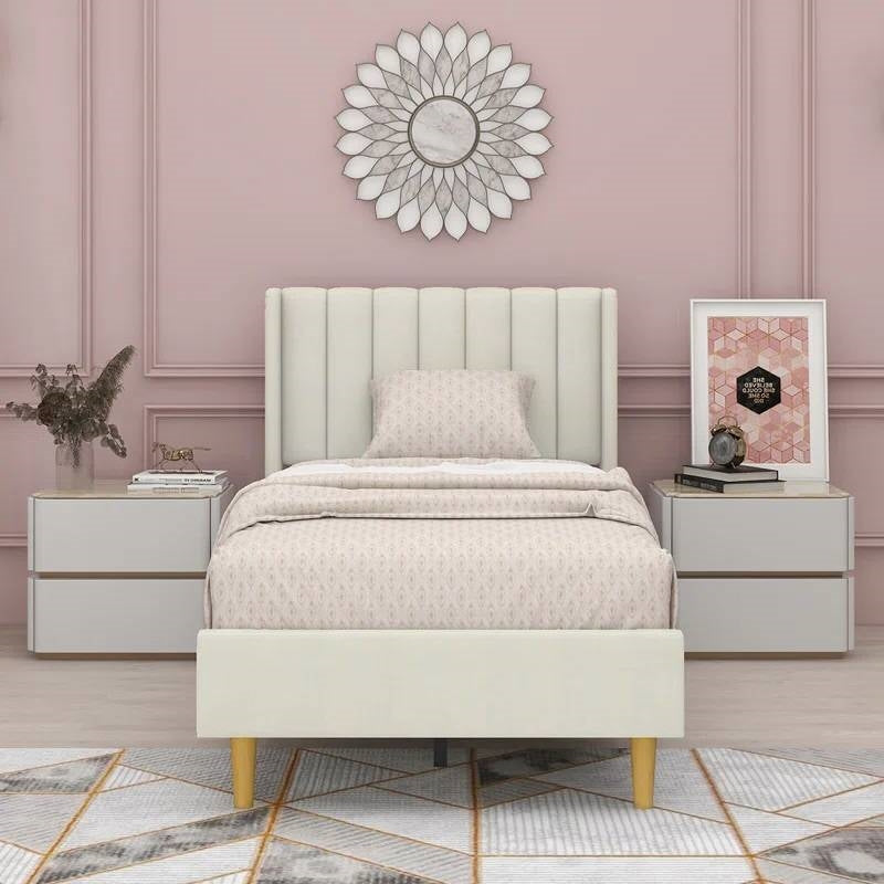 Neatly made bed with a decorative headboard in a stylish bedroom setting.