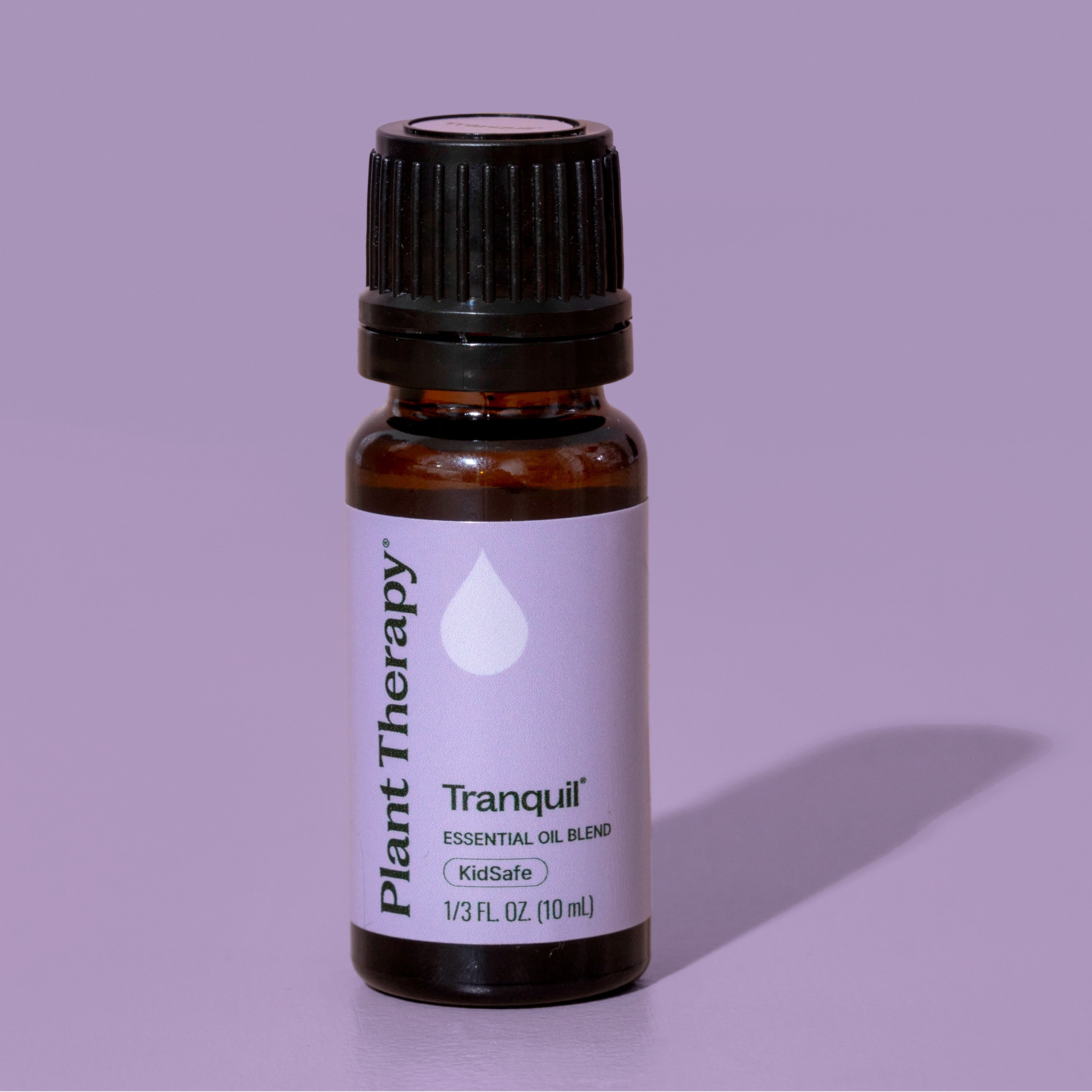 Bottle of Plant Therapy Tranquil essential oil blend on a purple background