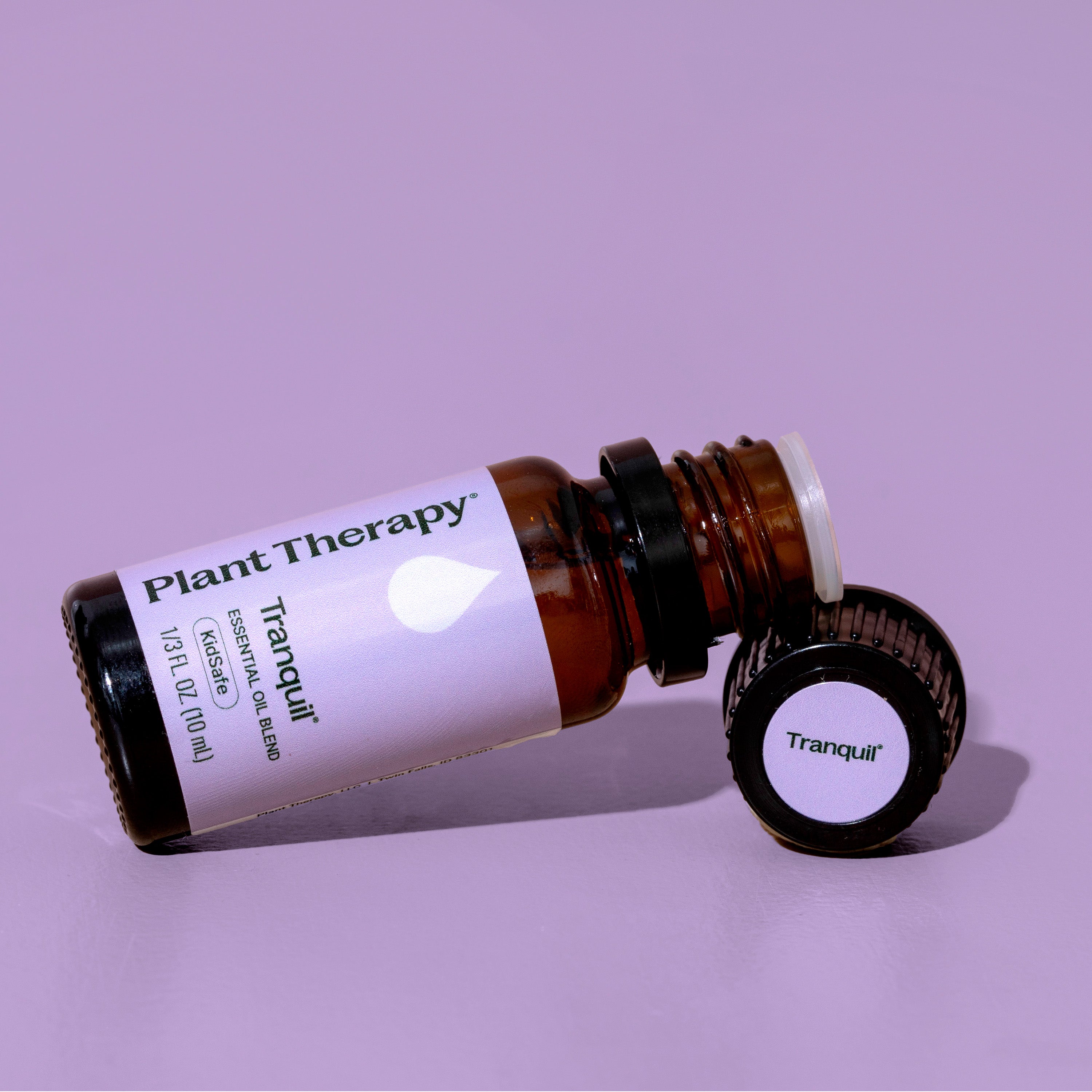 Plant Therapy Tranquil essential oil bottle on a purple background