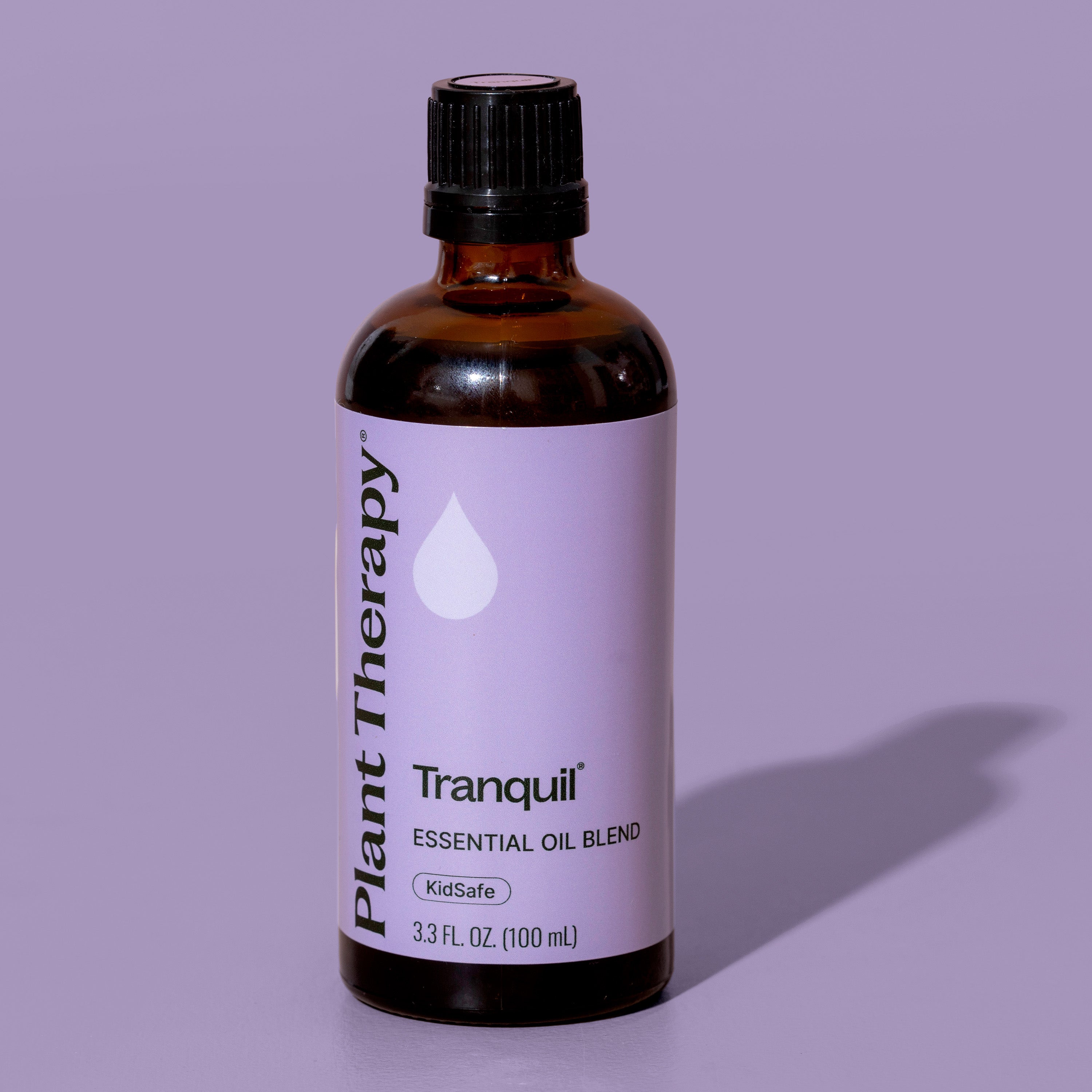 Bottle of Plant Therapy Tranquil essential oil blend on a purple background