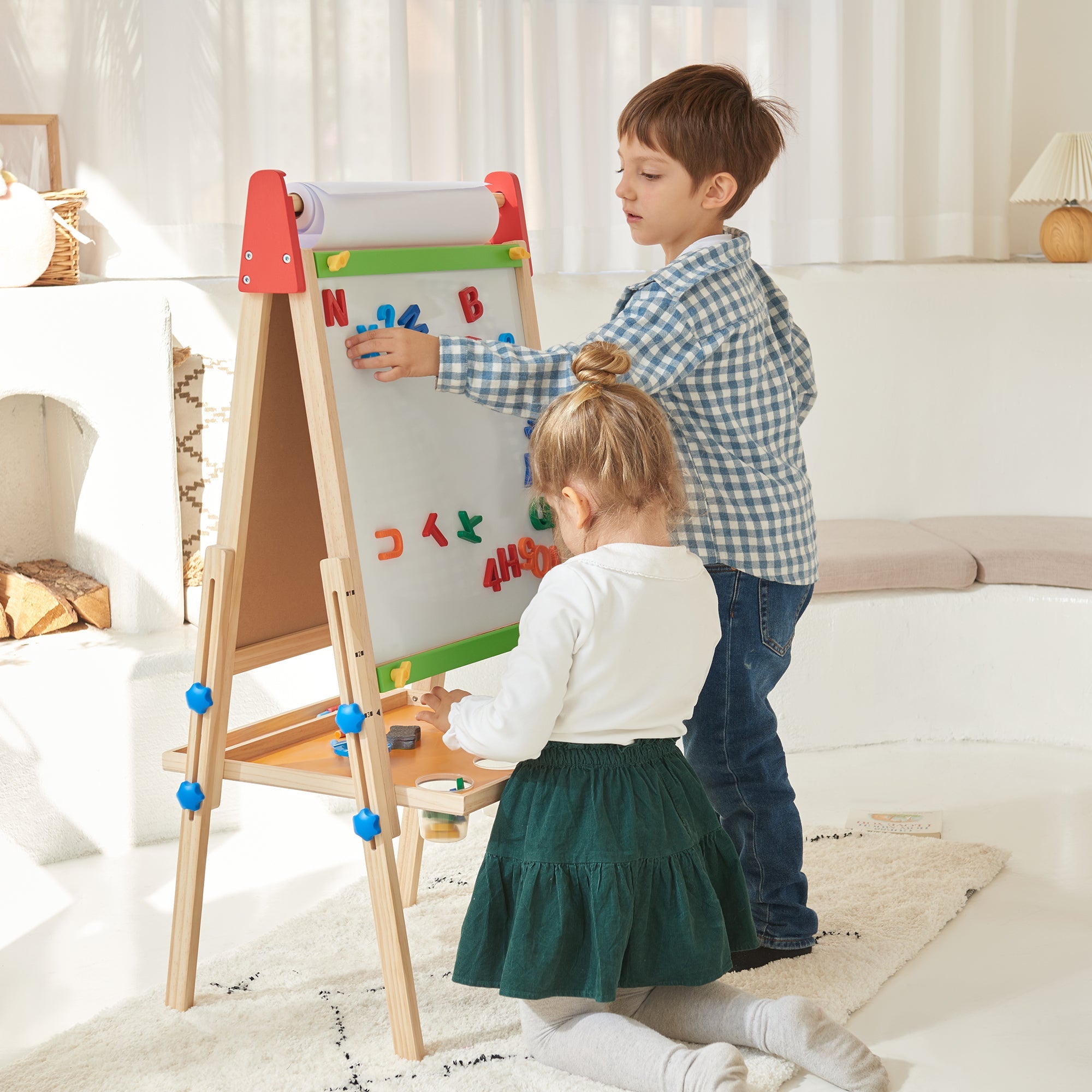 Child creating art on Tiny Land wooden easel
