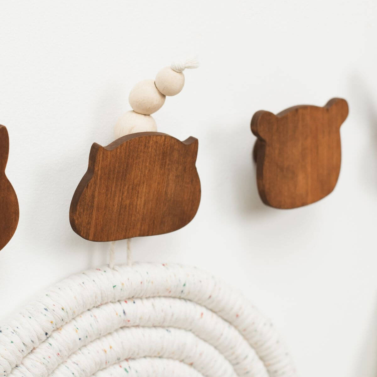 Wooden wall hooks shaped like animals on a white background