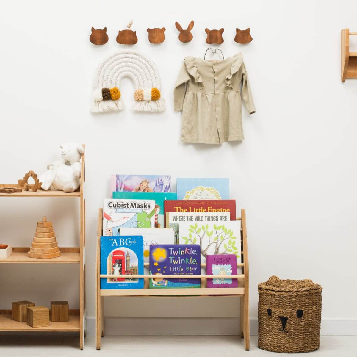 Children's room with books on a shelf, toys, and a coat hanging on a hook.