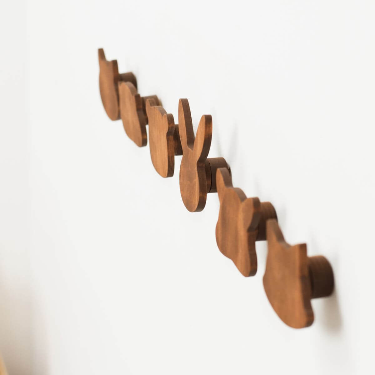 Wooden wall hook rack on a white background