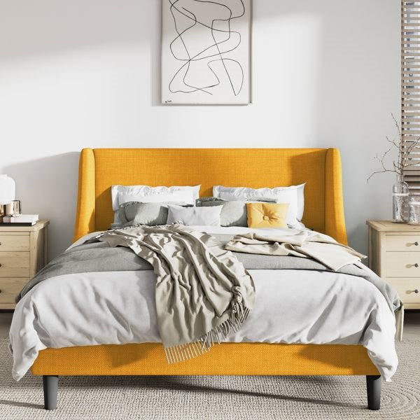 Bedroom with a bed featuring a yellow headboard and gray bedding.