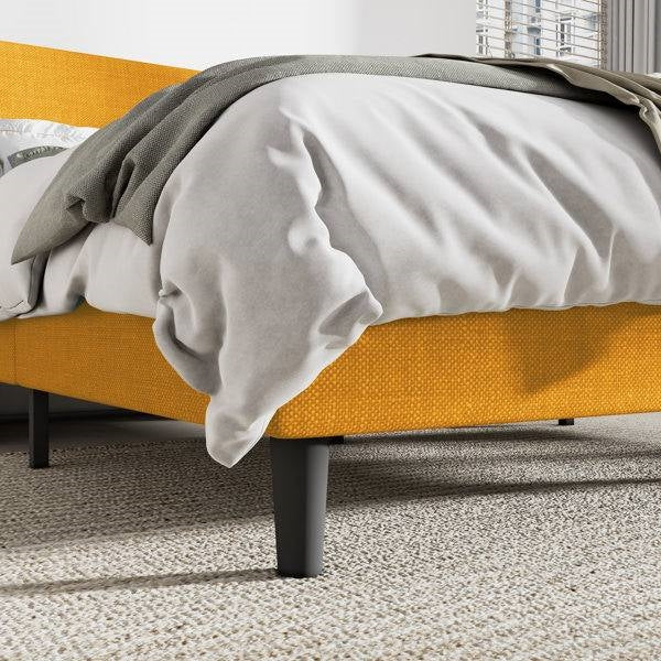 Yellow bed frame with gray bedding in a room setting