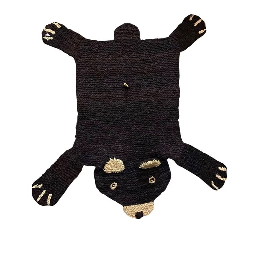 Organic wool brown bear nursery rug on white background showing hand-knit texture and design