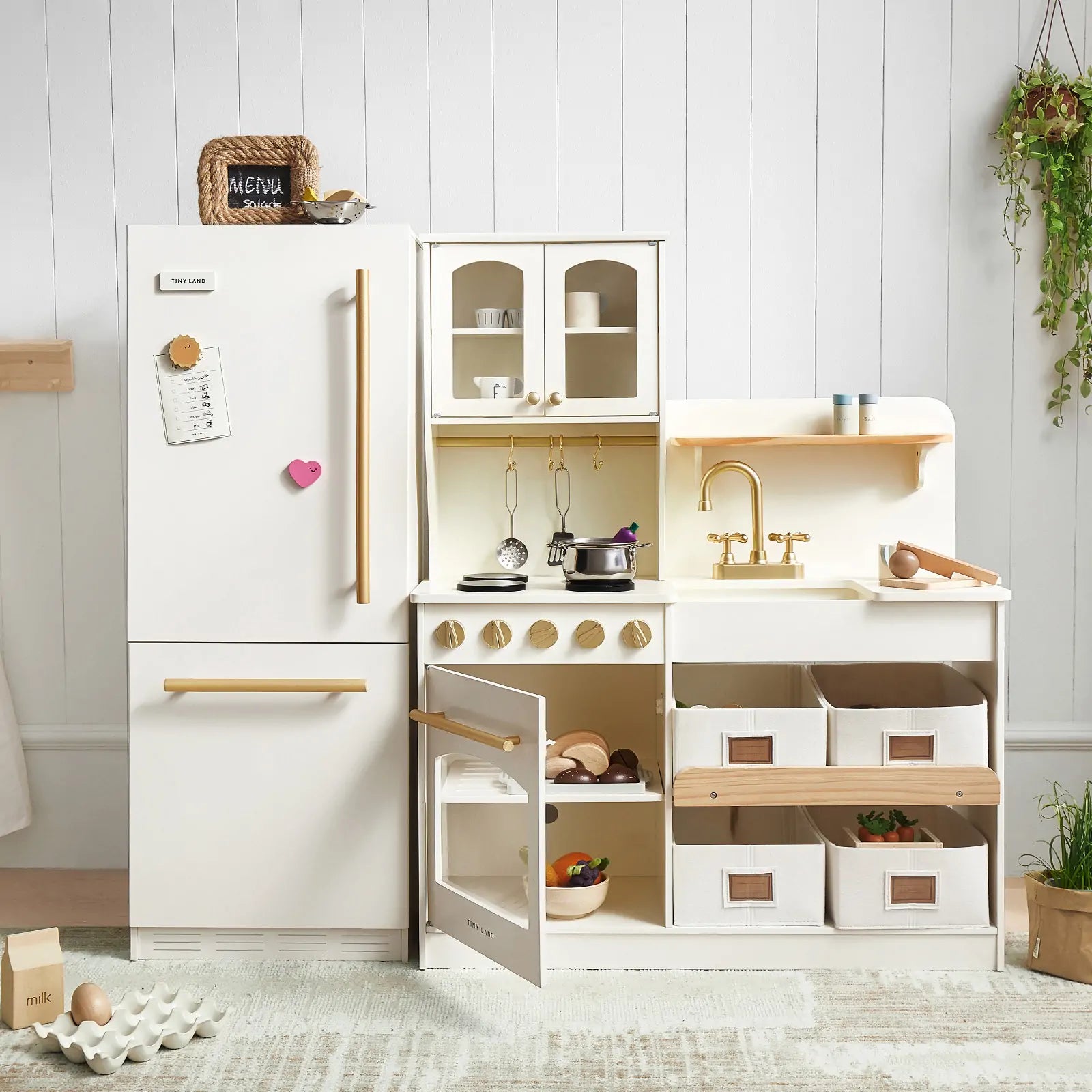 White wooded play kitchen set up in living room