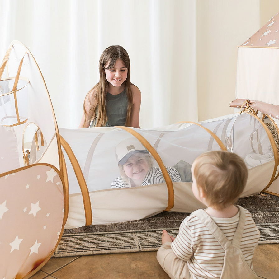 Children playing in Tiny Land mesh crawl tunnel showing active indoor imaginative play