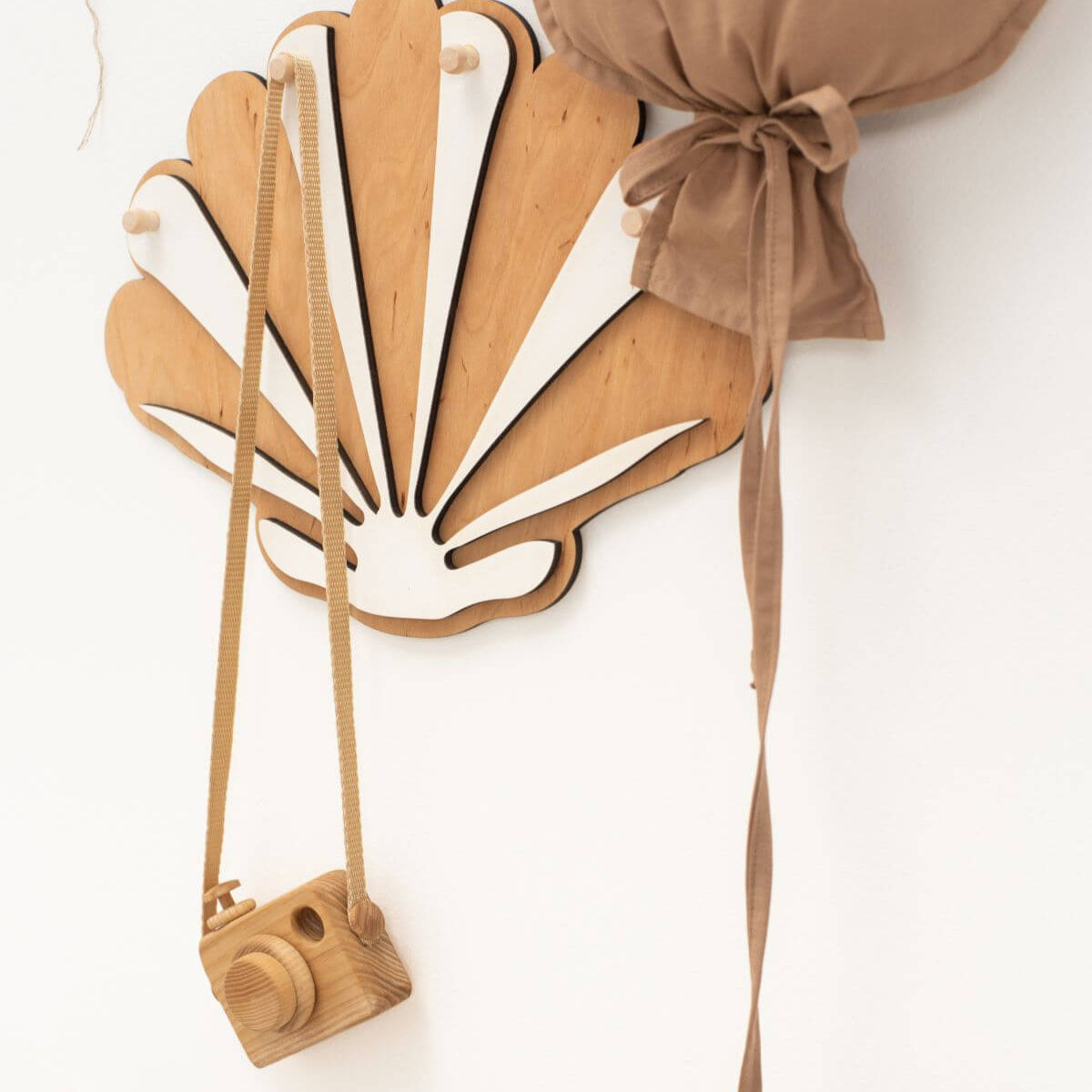 Wooden mask with a camera attachment on a white background