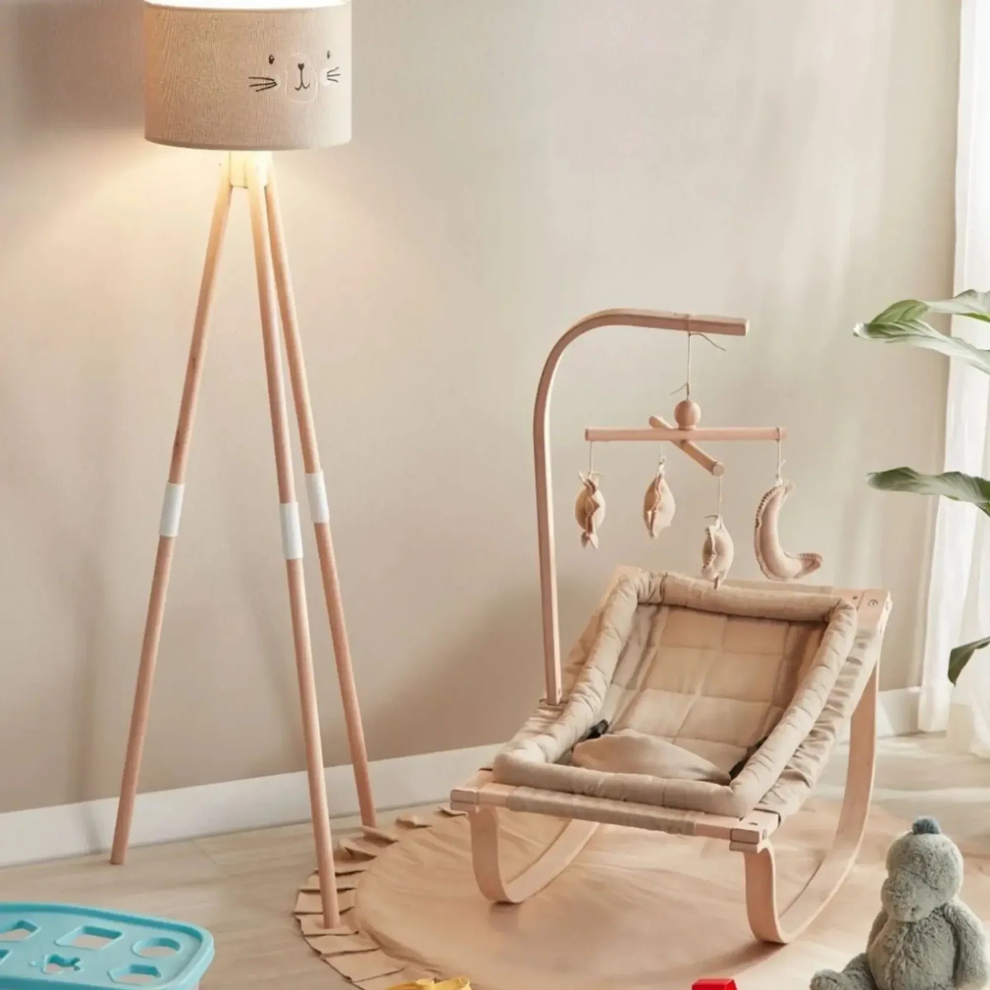 Children's room with a rocking chair, lamp, and toys.