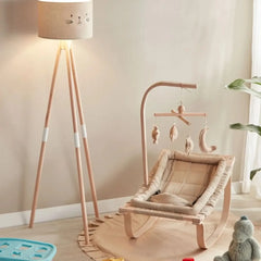 Children's room with a rocking chair, lamp, and toys.