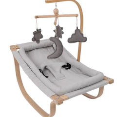 Baby bouncer with gray cushion and hanging toys on a white background