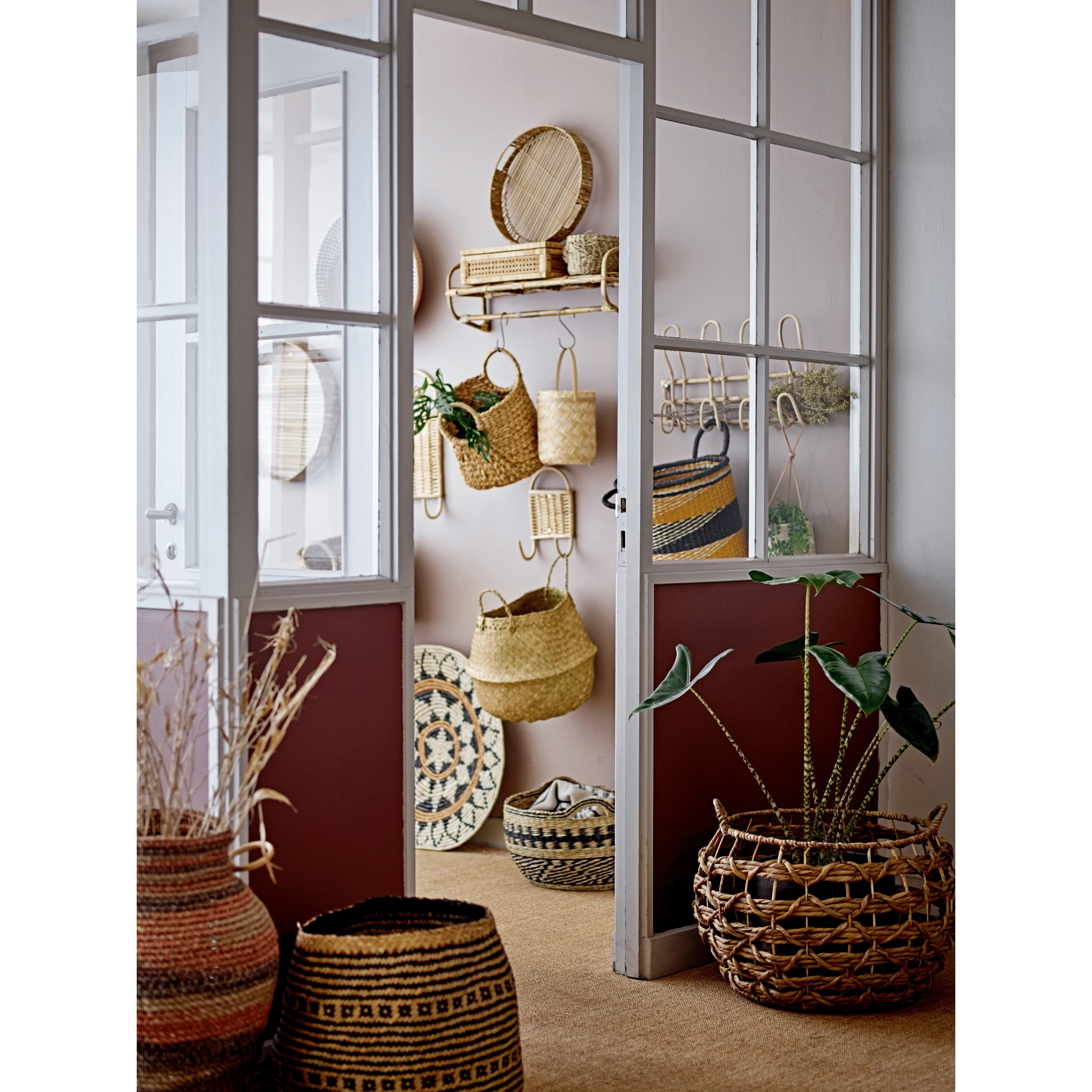 Room with wicker baskets and decor items displayed on a wall.