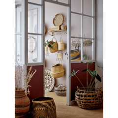 Room with wicker baskets and decor items displayed on a wall.