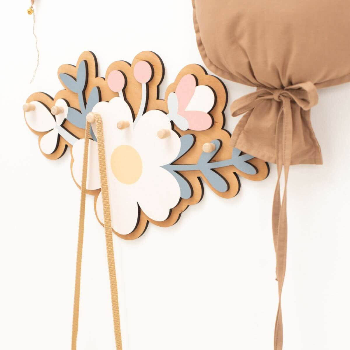 Decorative wall hanging with floral design on a white background
