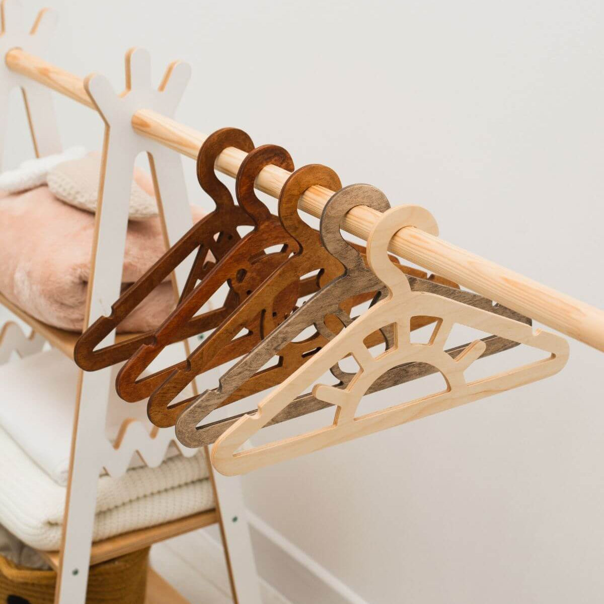 Set of wooden hangers on a rack with a neutral background