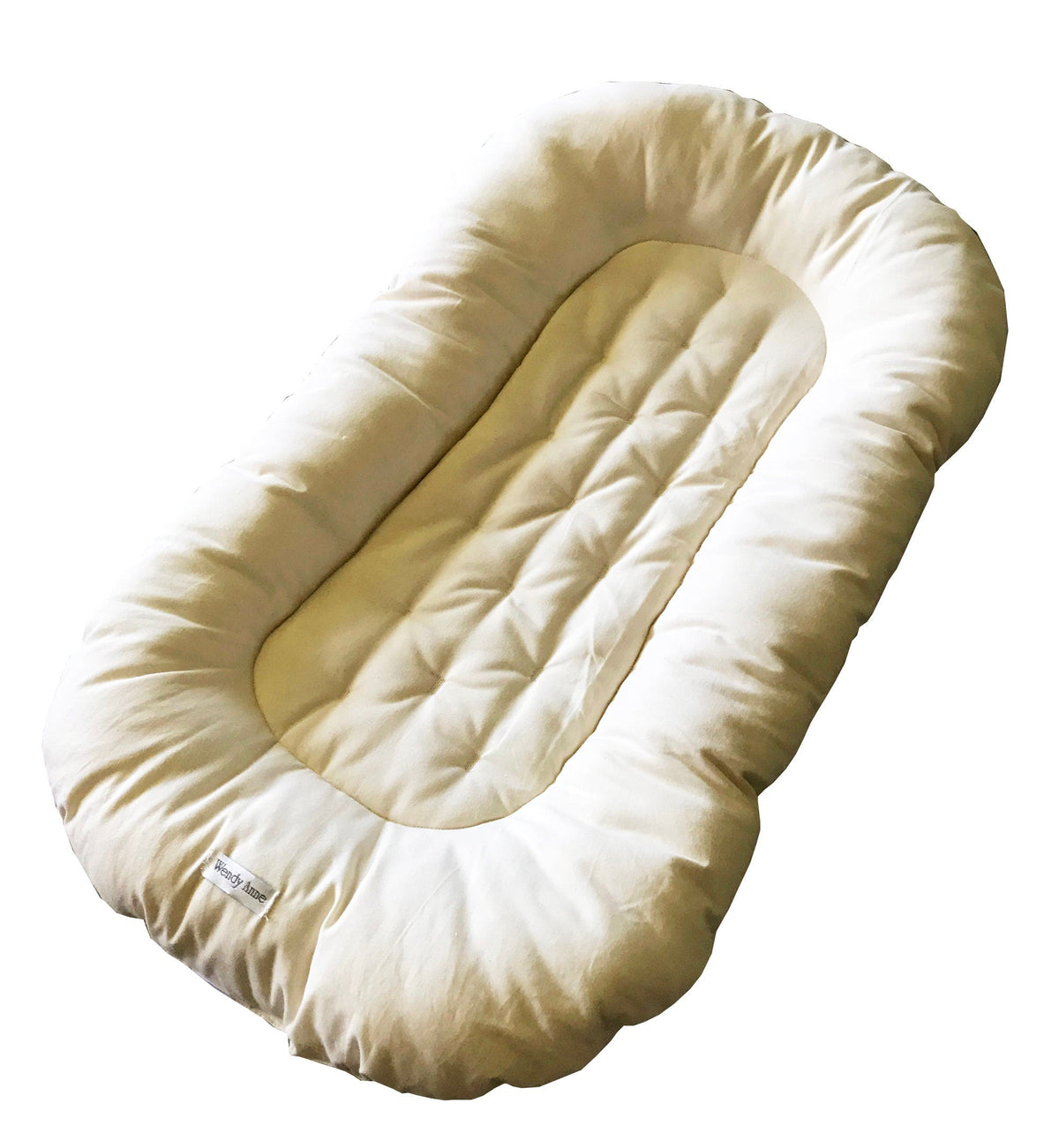 Cream-colored baby nest on a white background