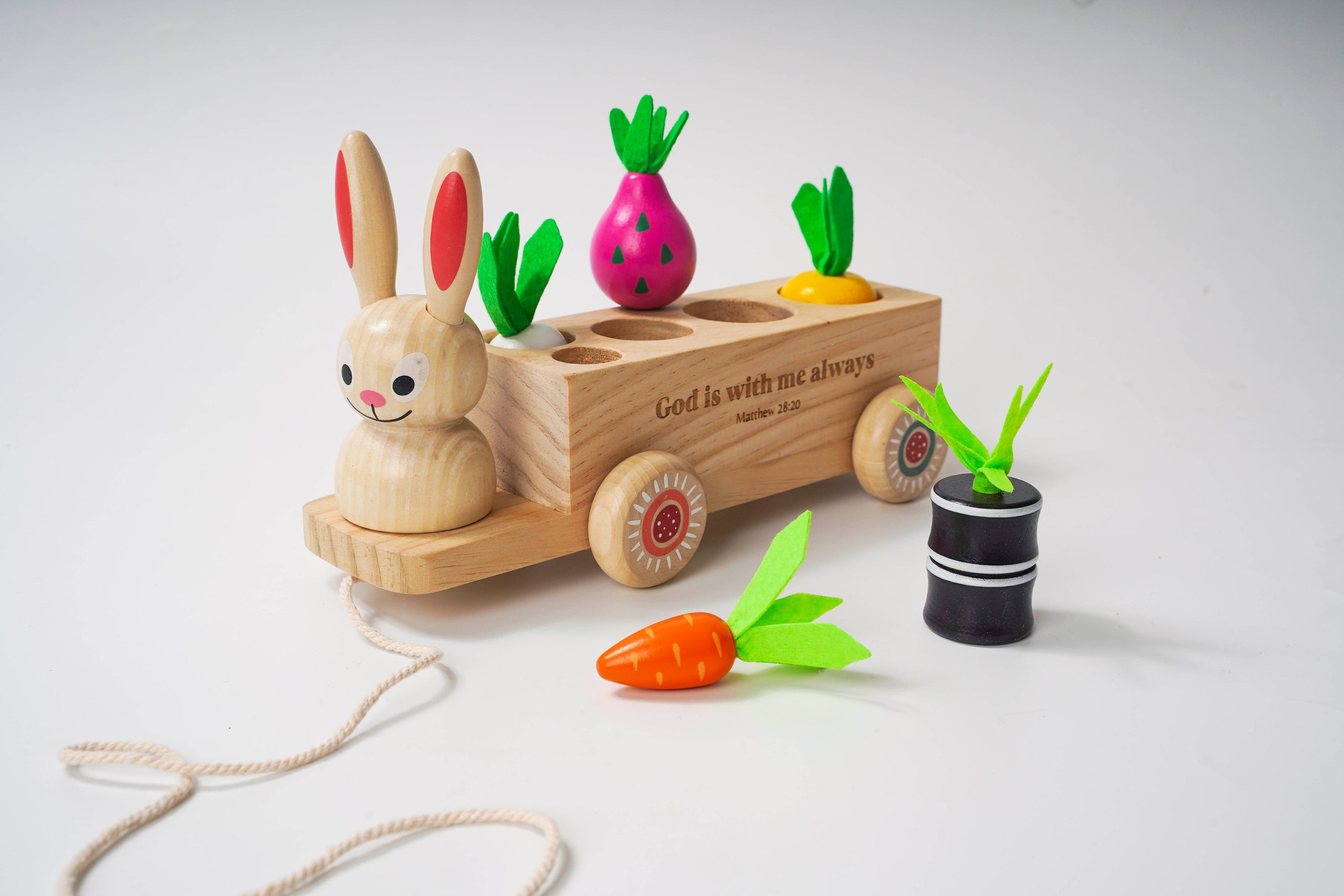Wooden toy with rabbit figure and colorful vegetables on a white background
