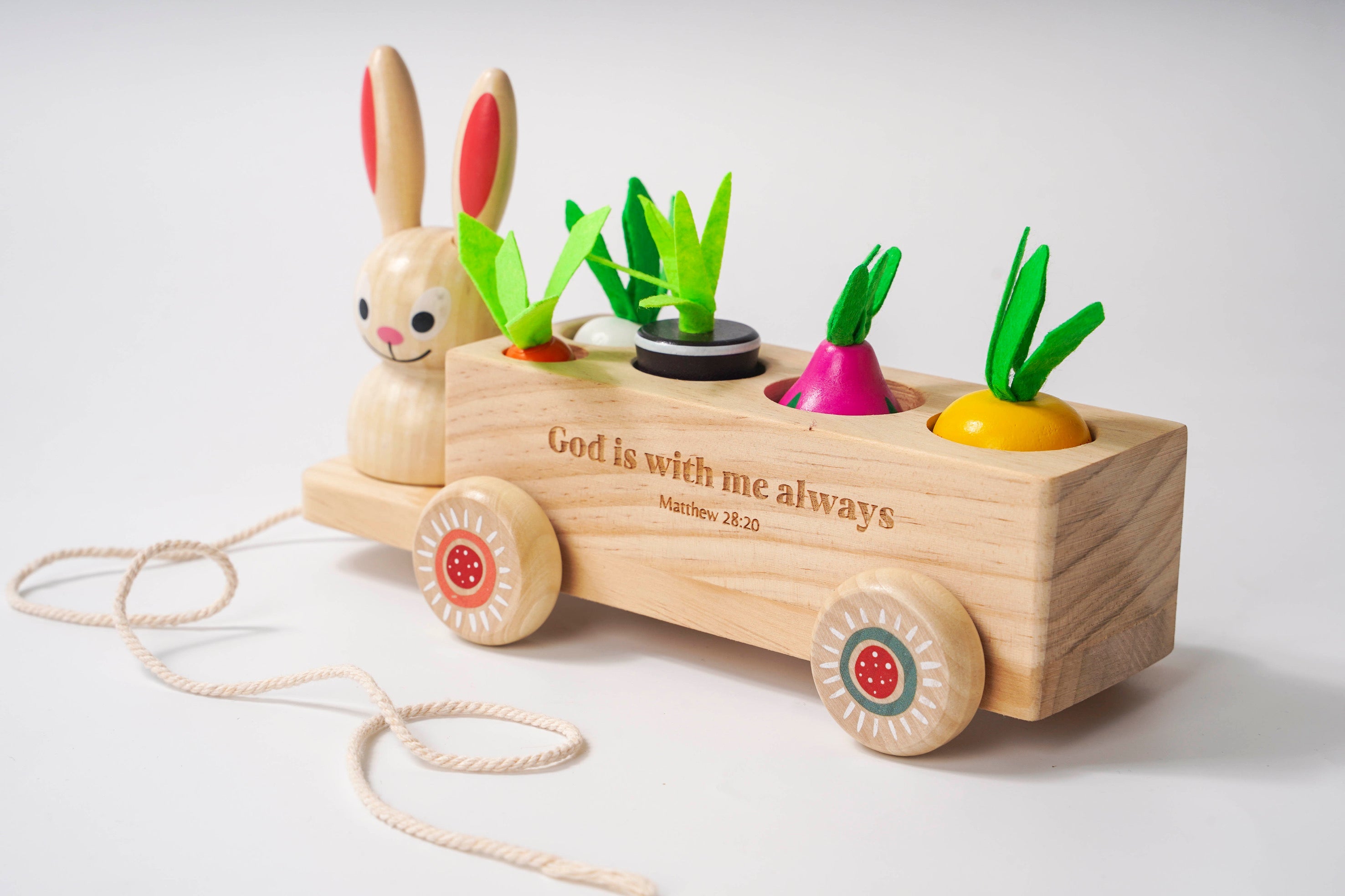 Wooden toy with a rabbit figure and colorful vegetables on a white background