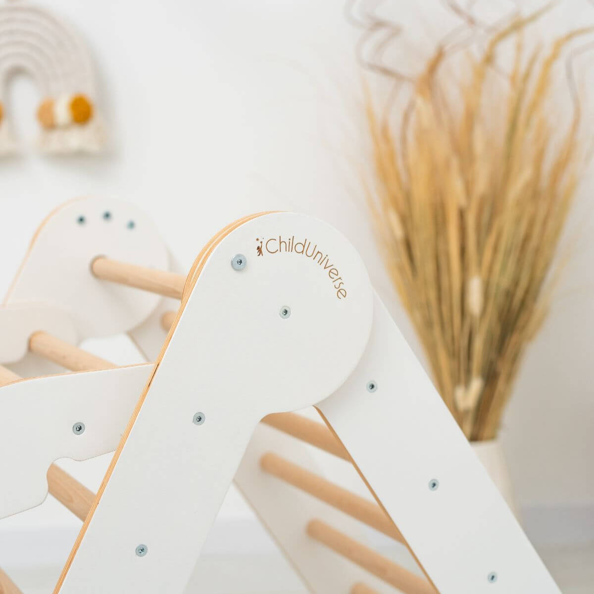 Children's wooden climbing toy with 'ChildUniverse' branding on a blurred background
