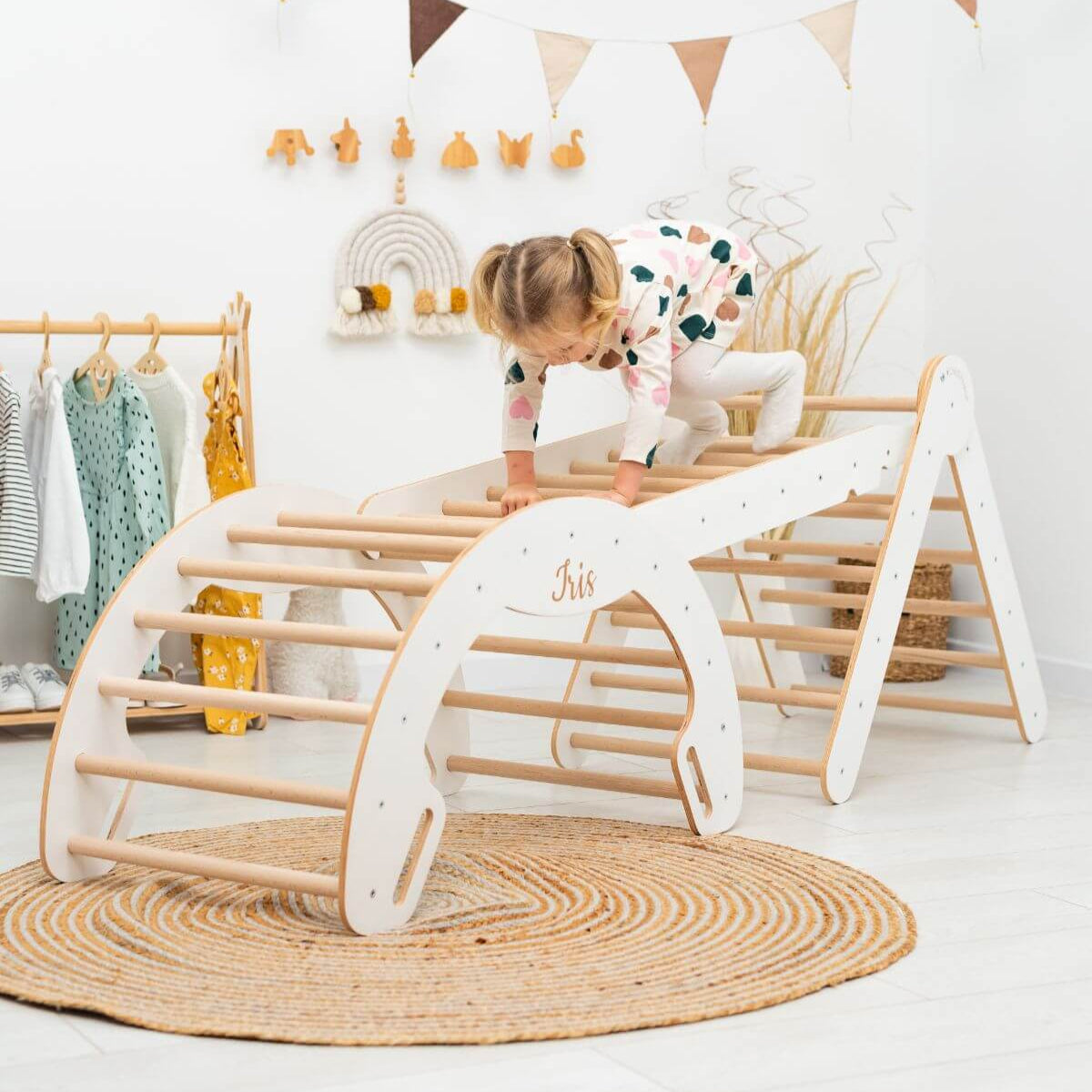 Children's play area with wooden climbing toy and child in the background