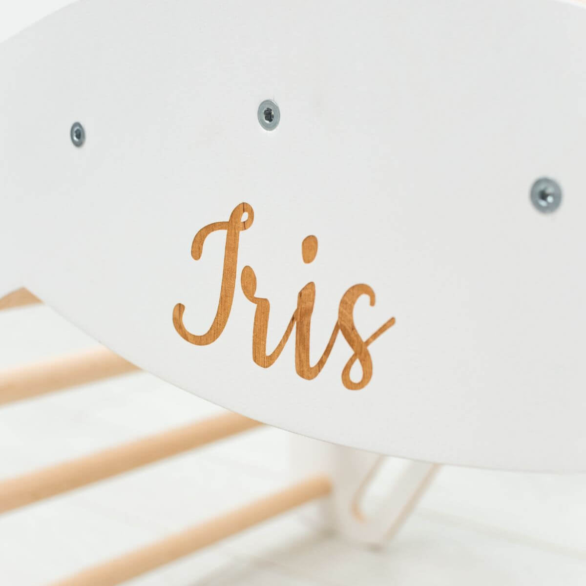 White card with 'Iris' written in gold on a white background