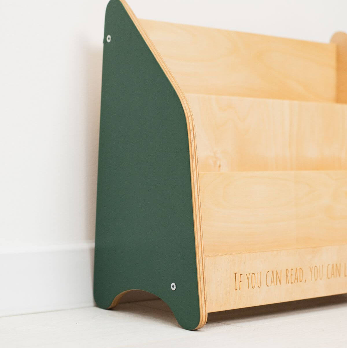 Wooden shelf with green backrest on a white background