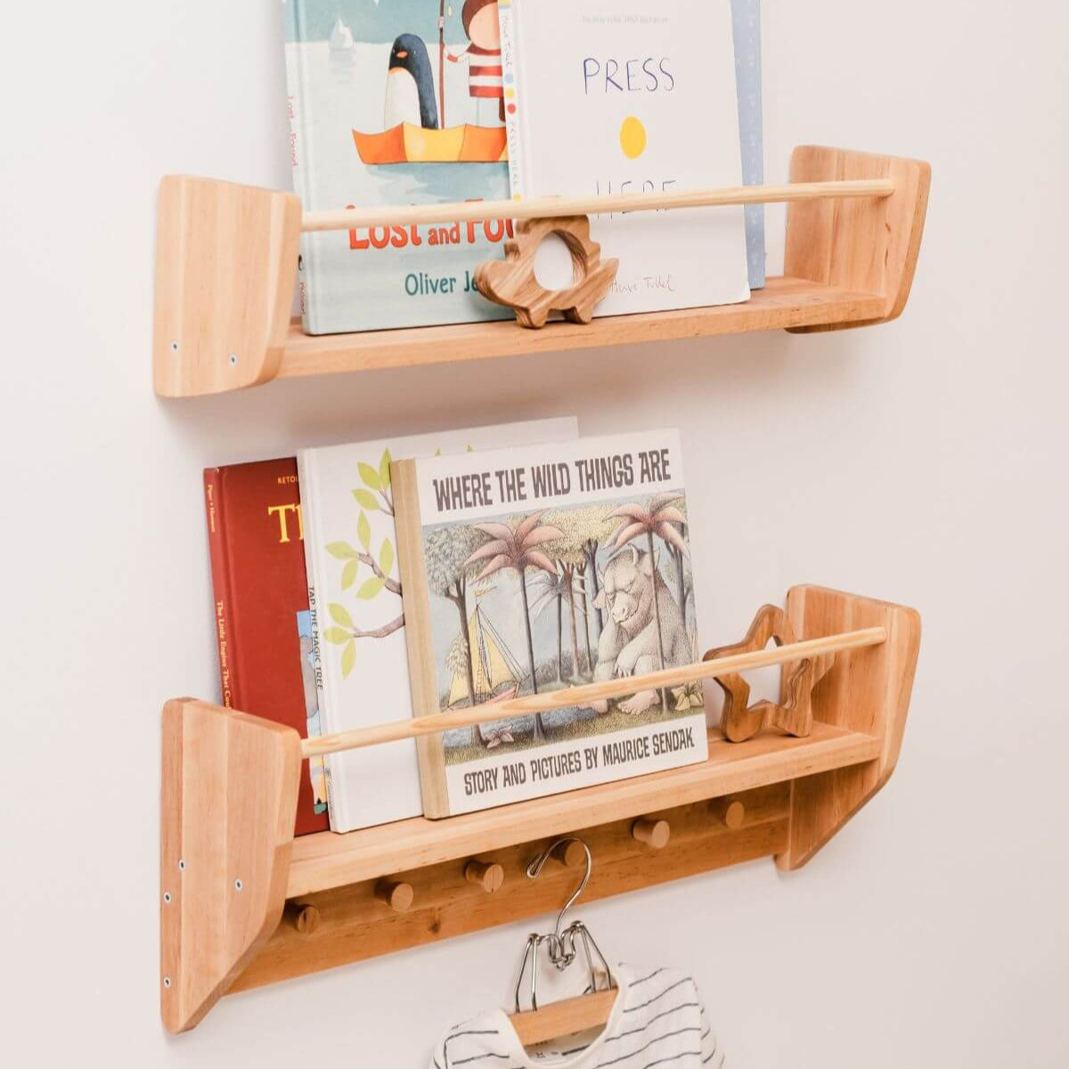Wooden wall shelf with books and a small figurine on a white background