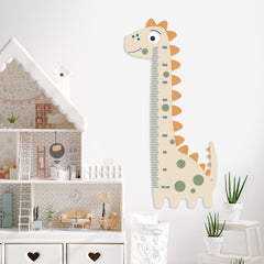 Dinosaur-shaped growth chart on a wall in a child's room with toys and furniture.